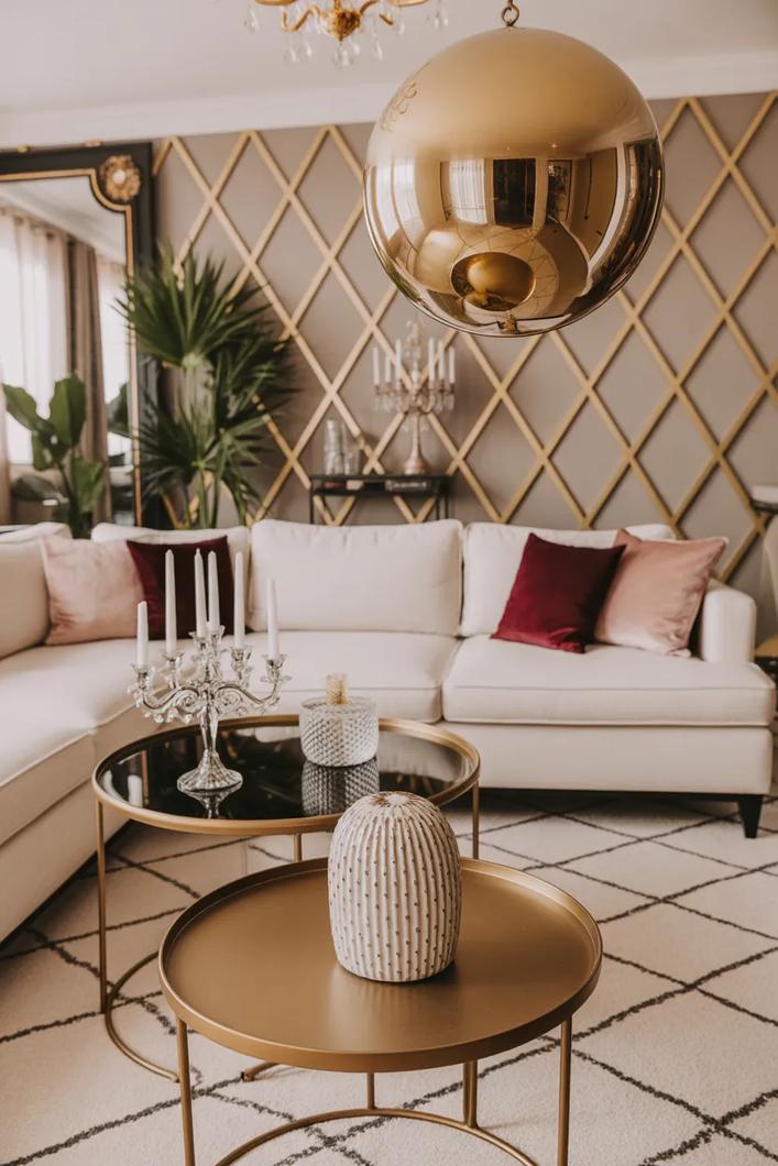 Plum velvet armchair, crystal pendant light, dark wood floor, and warm living room glow.