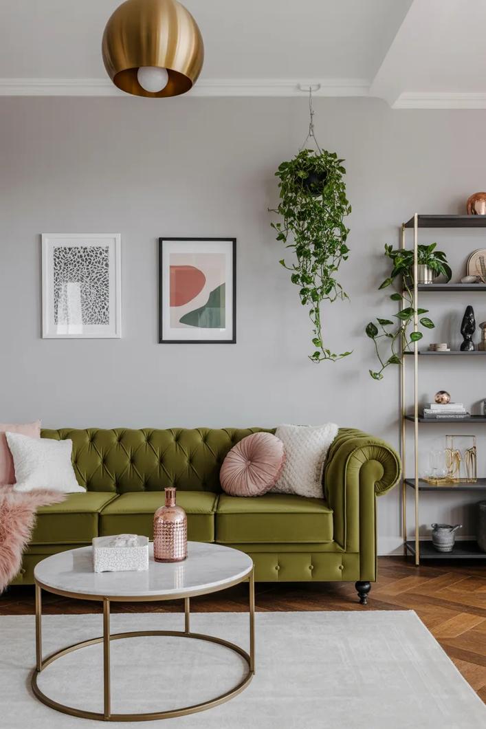 Ivory feather pillow, neutral sofa, white walls, and bright living room light.