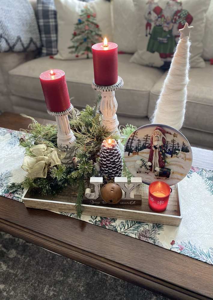 Elegant Christmas coffee table decor featuring metallic gold accents mixed with lush evergreen branches.