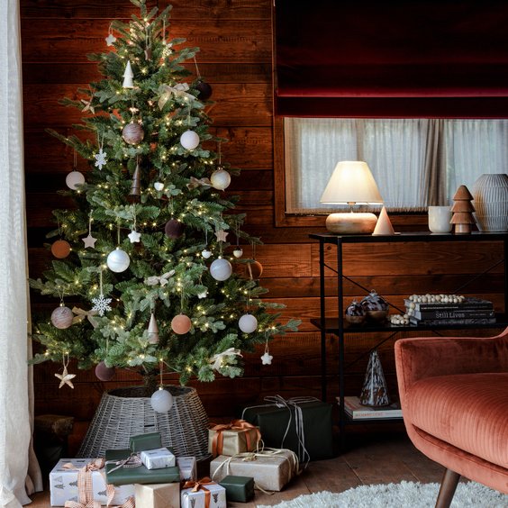 Scandinavian neutral living room tree with soft gold ribbon, boucle sofa, minimalist floor lighting