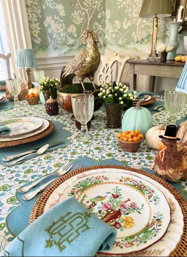 Vintage-inspired dining, blue patterned plates, pastel china, brass cutlery, soft ivory tablecloth