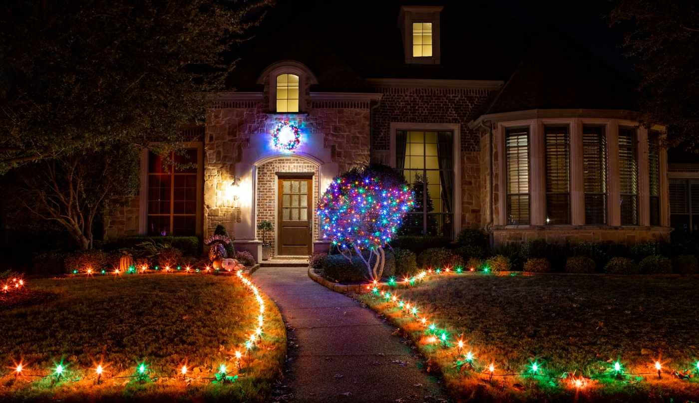 Clean outdoor walkway lined with low profile warm LED ground stakes leading to stone steps