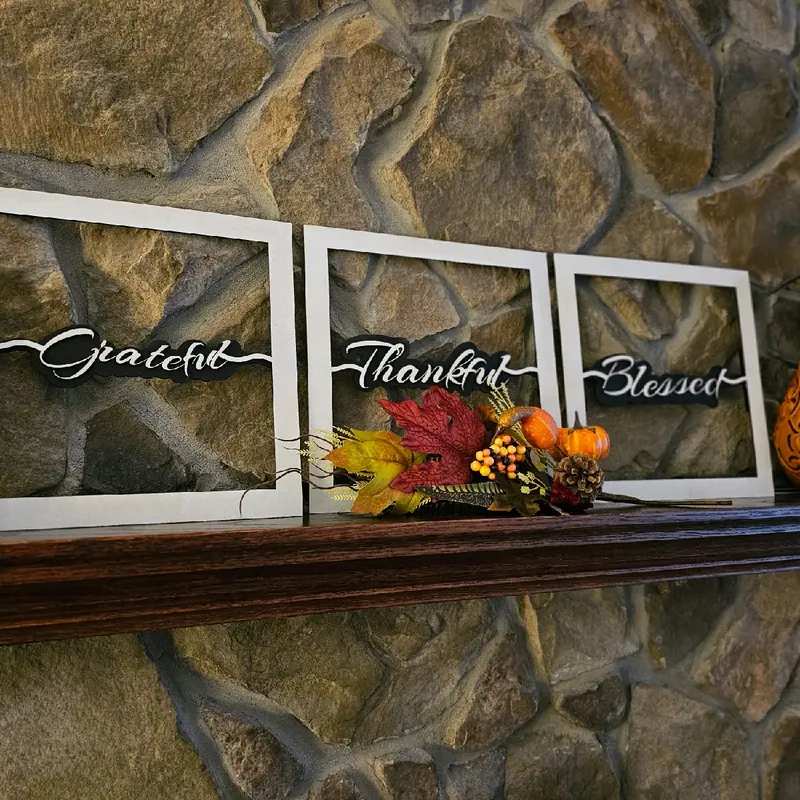 Entryway console with three framed signs, each with a different word, neutral rug, soft lighting.