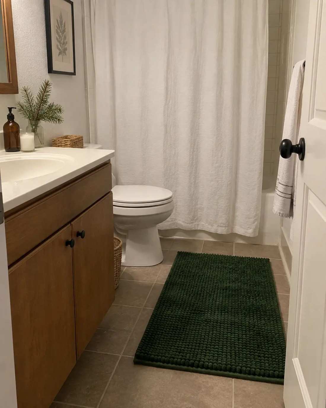 Deep green plush bath mat, white tile floor, cozy texture, festive floor accent