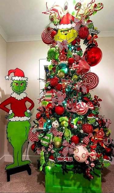 Tree with Grinch legs and Whoville signs in a bright room