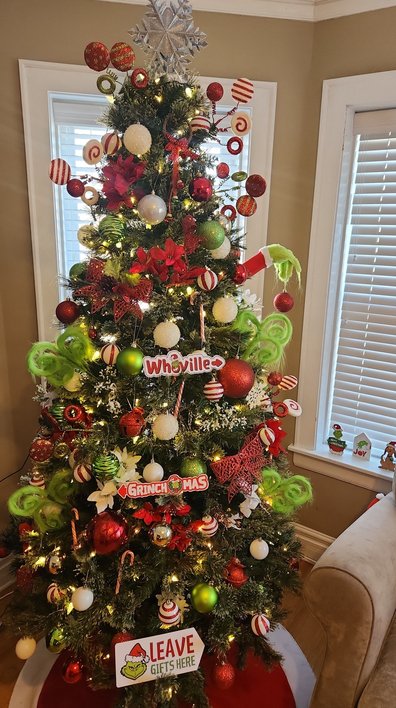 Tree with red candy canes and glossy red balls on green branches
