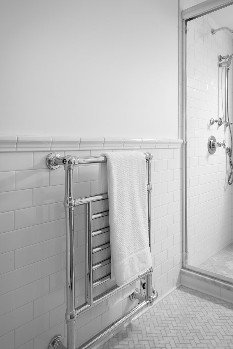 Clean and bright guest bathroom with classic white subway tiles in the shower area.