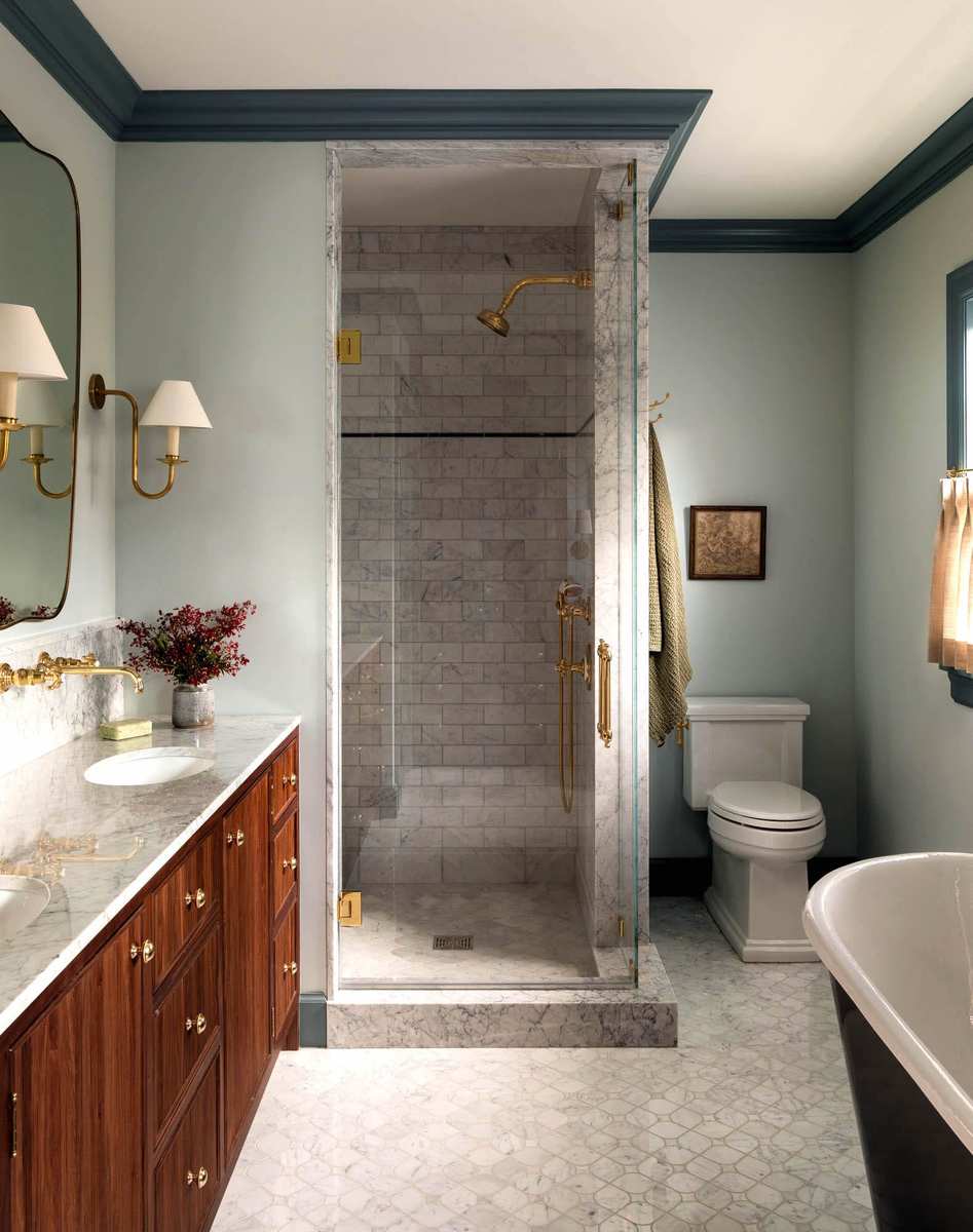 Guest bathroom featuring a natural wood vanity and a large glass-enclosed shower area.