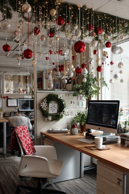String of gold and red glass ornaments hanging vertically beside a white office door frame.
