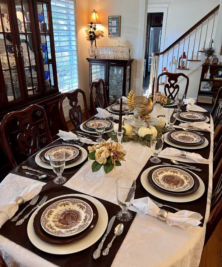 Classic dining room, heirloom turkey dinner plates, gold bird centerpiece, polished oak table, soft lighting