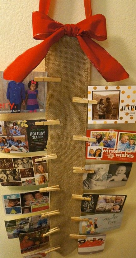Natural woven burlap vertical wall runner with French stripe ribbon holding holiday greeting cards
