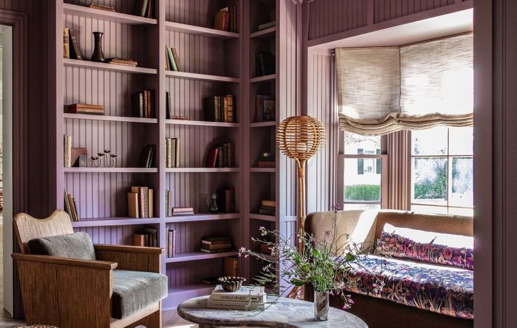 Minimalist Japandi living room with low slatted wood wall panel, beige sofa, floor lamp.