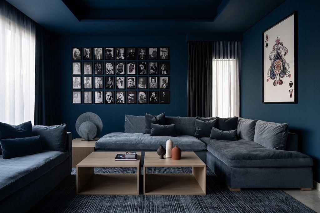 Modern minimalist small living space showcasing clear glass coffee table and shearling armchair.