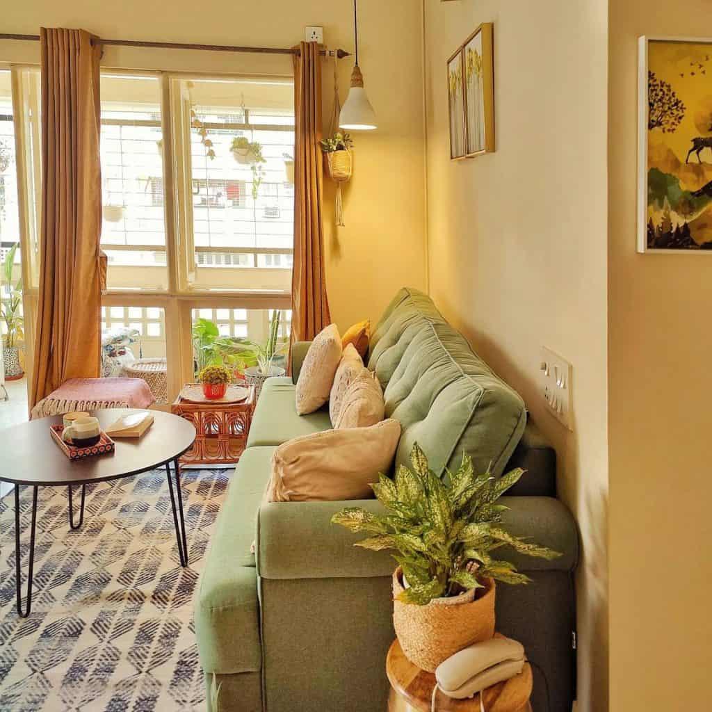Modern small living room using transparent acrylic coffee table and glass lighting for visual lightness.