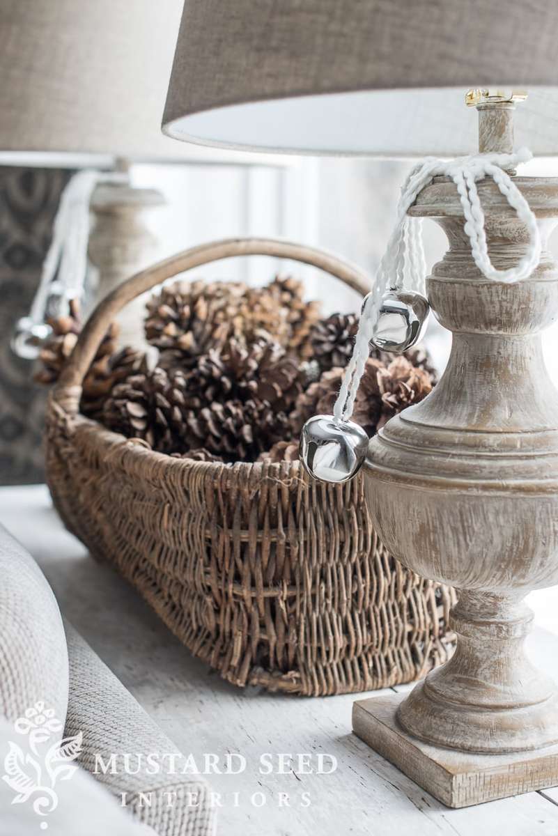 Cozy nook featuring mini tree with craft jingle bells, oak table, wool throw, and warm lighting.
