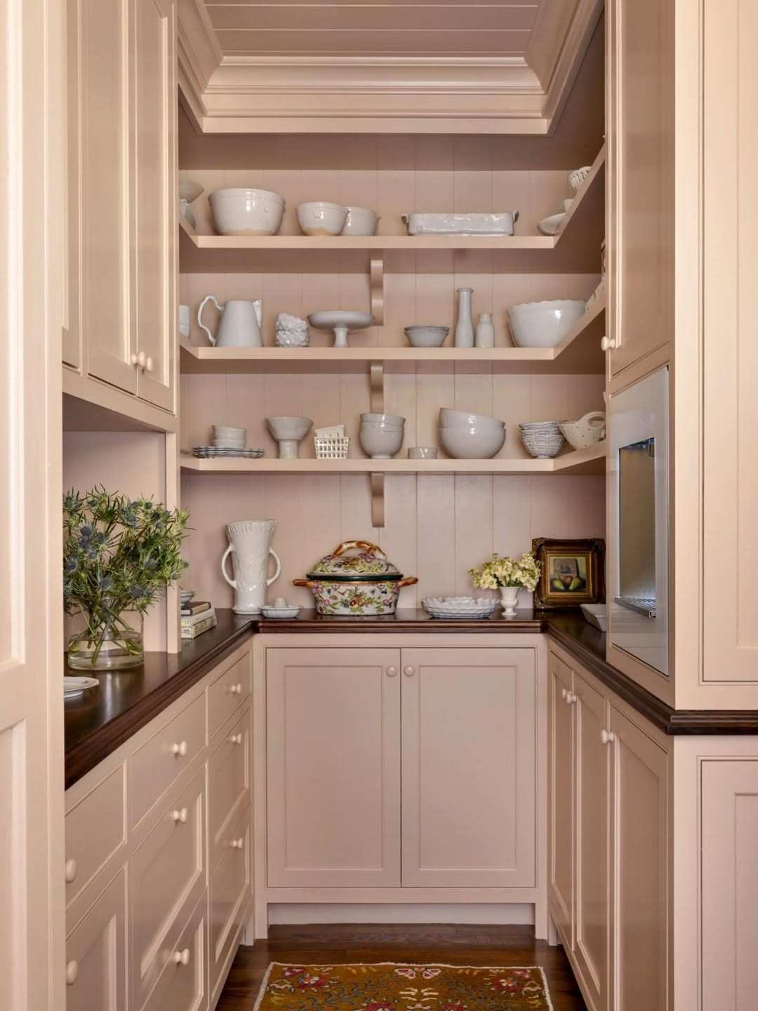 Soft blush pantry doors with delicate brass knobs in a bright, modern farmhouse kitchen.