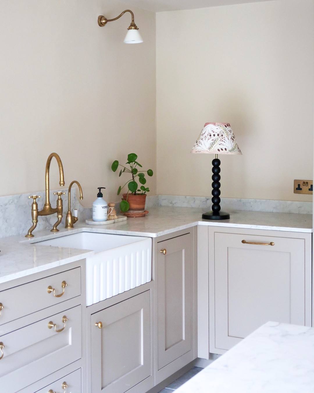 Cozy farmhouse kitchen with brass knobs and warm wood tones in a rustic space.