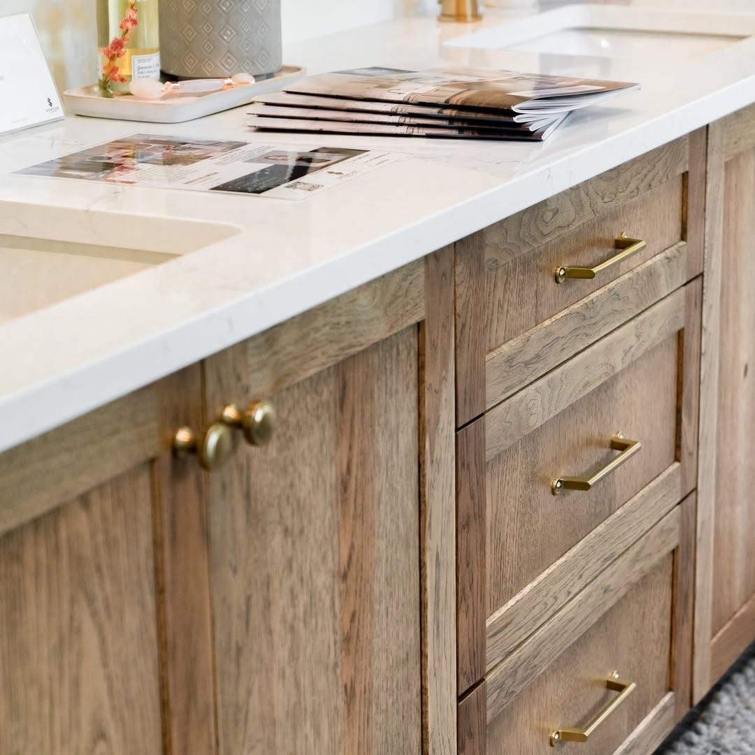 Beautiful natural wood drawers accented with classic brass knobs.