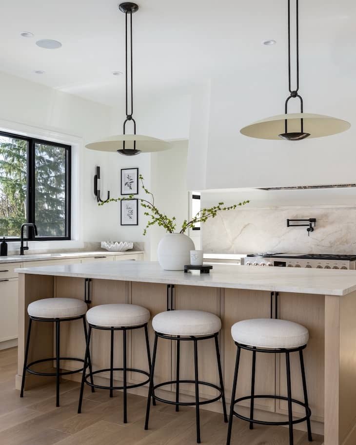 Farmhouse kitchen with cream shaker cabinets, wooden butcher block counters, and iron pulls.