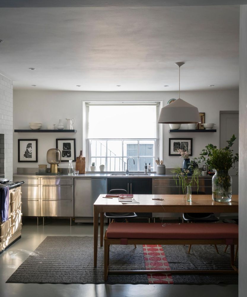 Kitchen with floor to ceiling hidden cabinetry, smart appliances, and clean lines.