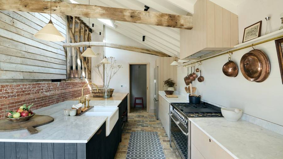 Kitchen with light wood tones, paper lanterns, bamboo accents, and neutral plaster walls.