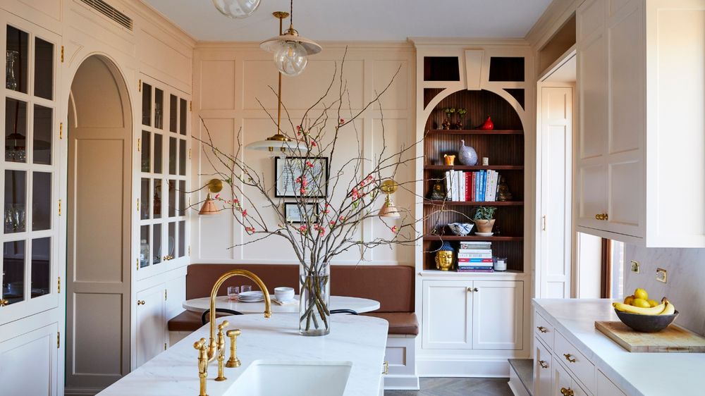 Small pantry area with coffee bar, hidden appliances, and glass cabinetry.