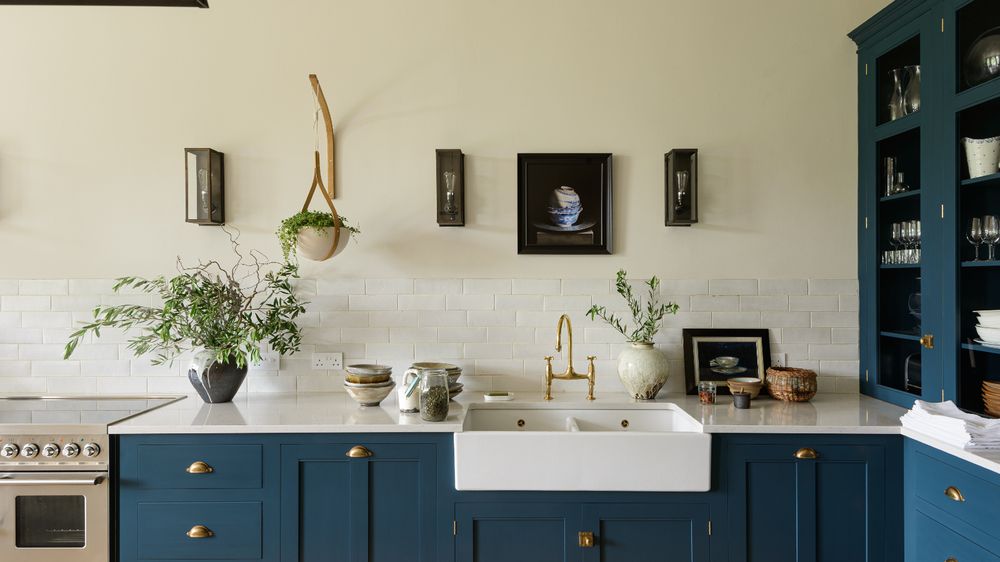Kitchen island with a built-in trough for fresh herbs, stone counters, and sunlight.