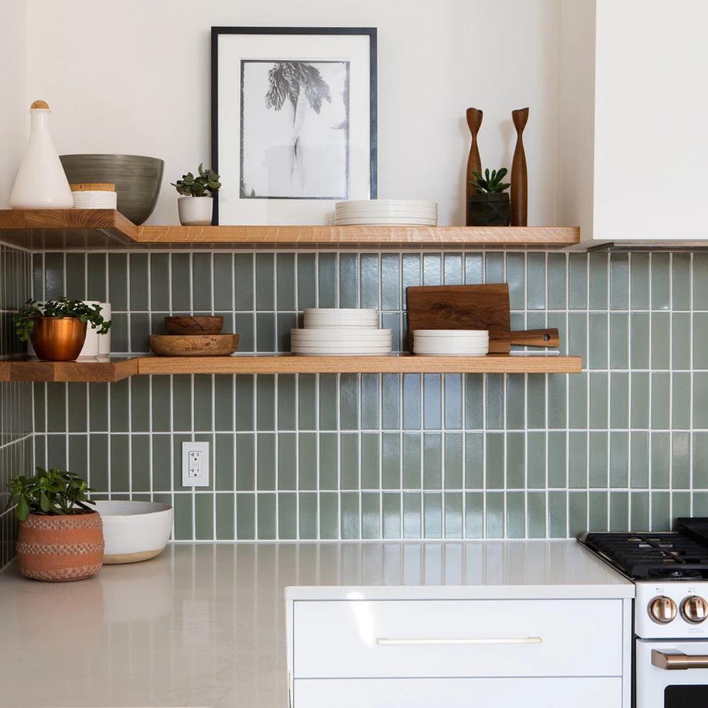 Kitchen with hand-blown glass pendants, light wood surfaces, and warm white light.