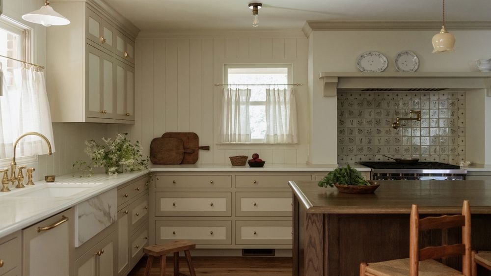 Modern kitchen with touch-screen refrigerators and voice-controlled smart lighting systems.