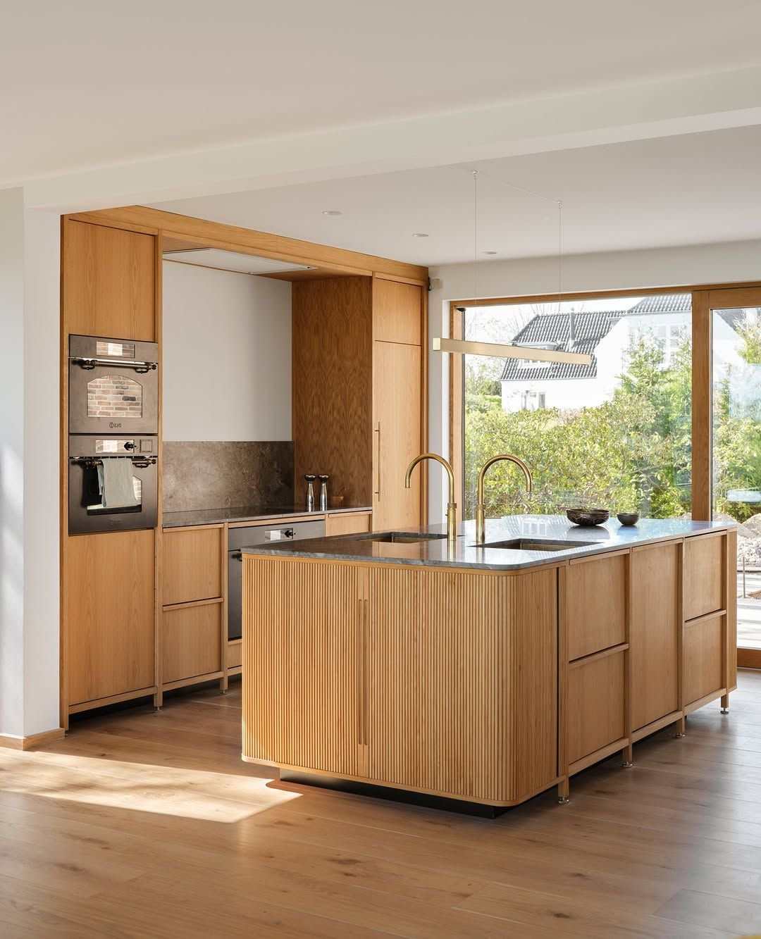 Spacious luxury kitchen with two parallel islands, one for cooking prep and one with bar seating.
