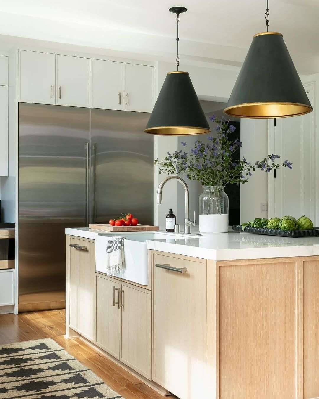 Small kitchen featuring a mobile wooden cart island with lockable casters and open slatted storage shelves.