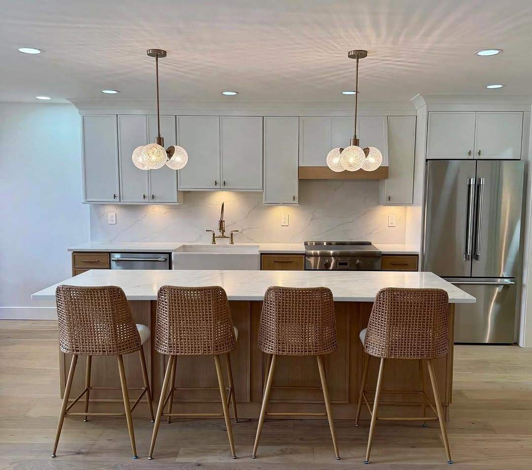 Playful modern kitchen featuring a custom terrazzo topped island with a terracotta painted cabinet base.