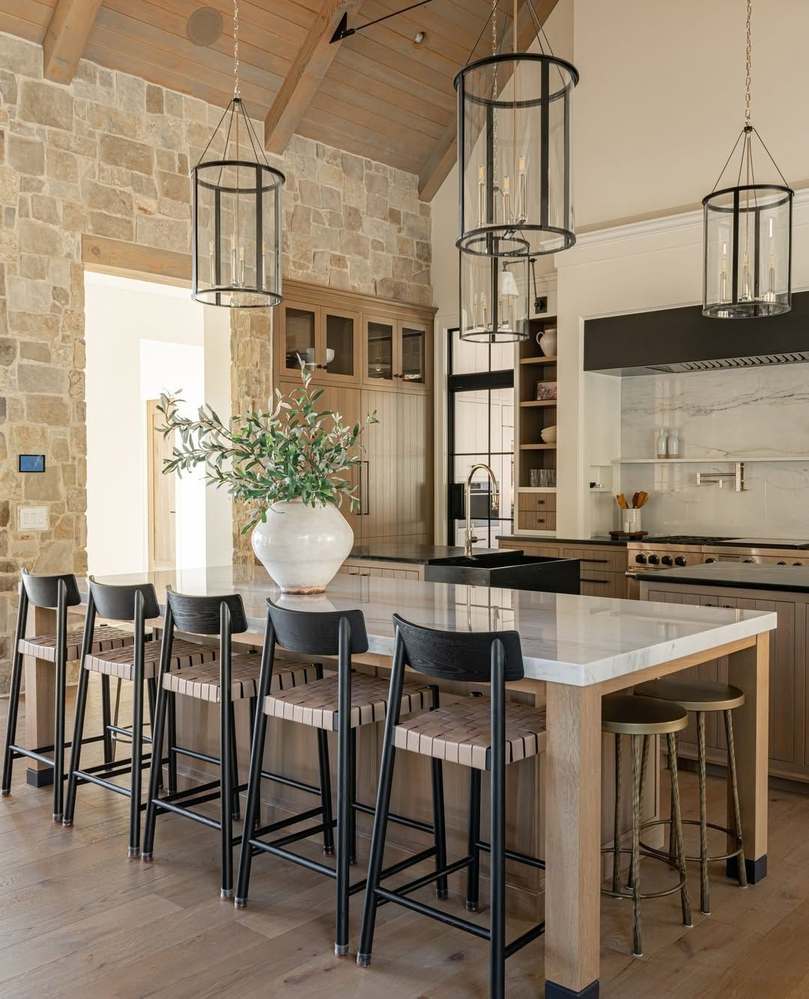 Functional kitchen island featuring integrated under-counter wine fridge, glass rack storage, and prep sink.