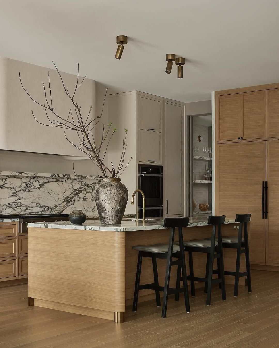 Moody high-end kitchen island built from dark American walnut with a velvety honed black soapstone top.