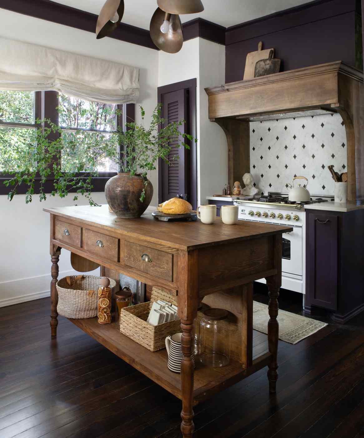 A bold kitchen island with a smooth grey concrete countertop and dark charcoal base.