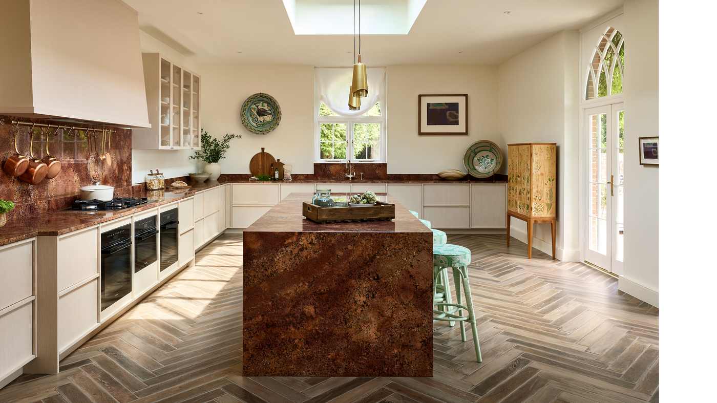 A large kitchen island with two levels, one for cooking and one for dining.