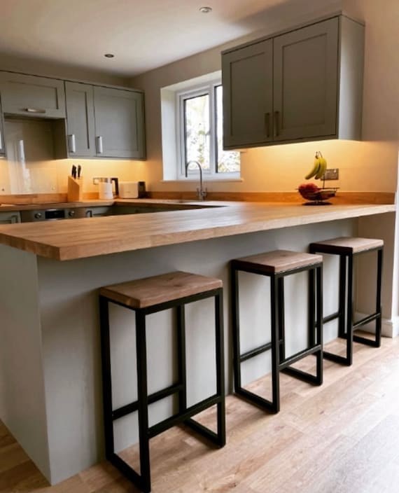 A luxurious kitchen island with mirrored panels and gold metallic trim.