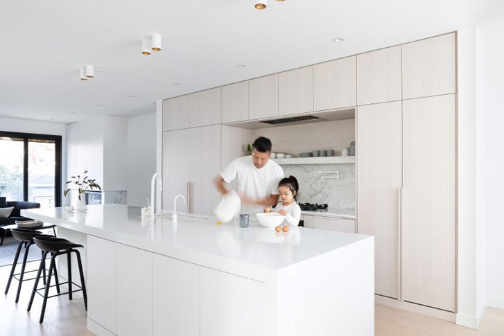 A long kitchen island with an attached table extension for additional seating.