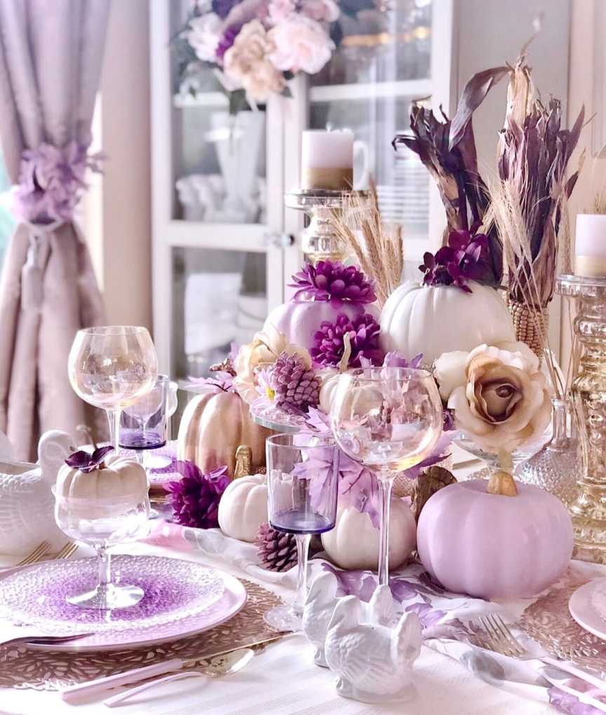 Dining table with lavender linens, purple glassware, gold accents, soft chandelier lighting, elegant vibe