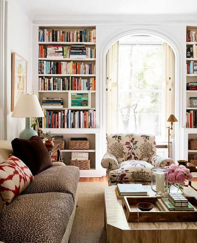 Living room arched window, oversized knit chair, woven pouf, natural wood floor, soft pendant lighting.