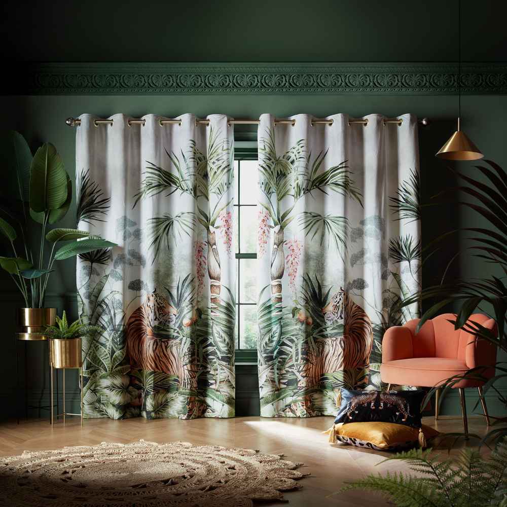 Living room featuring double curtain rods, sheer white drapes underneath, heavy blackout curtains on top.