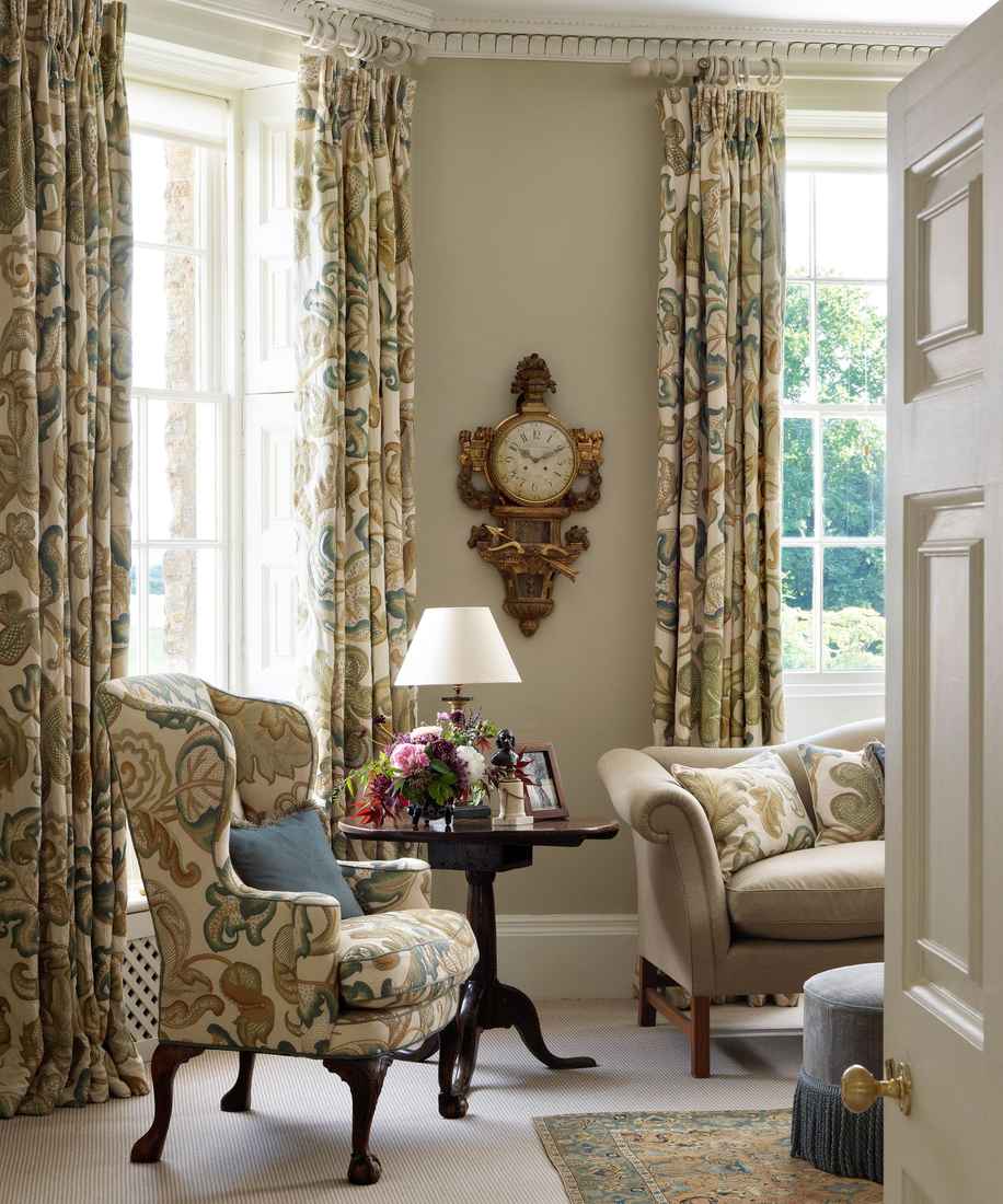 Floor to ceiling light linen curtains in a bright modern living room with natural light.