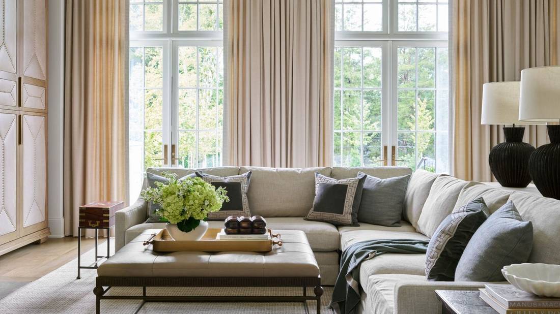 Grey metallic grommet curtains in an industrial style loft living room.