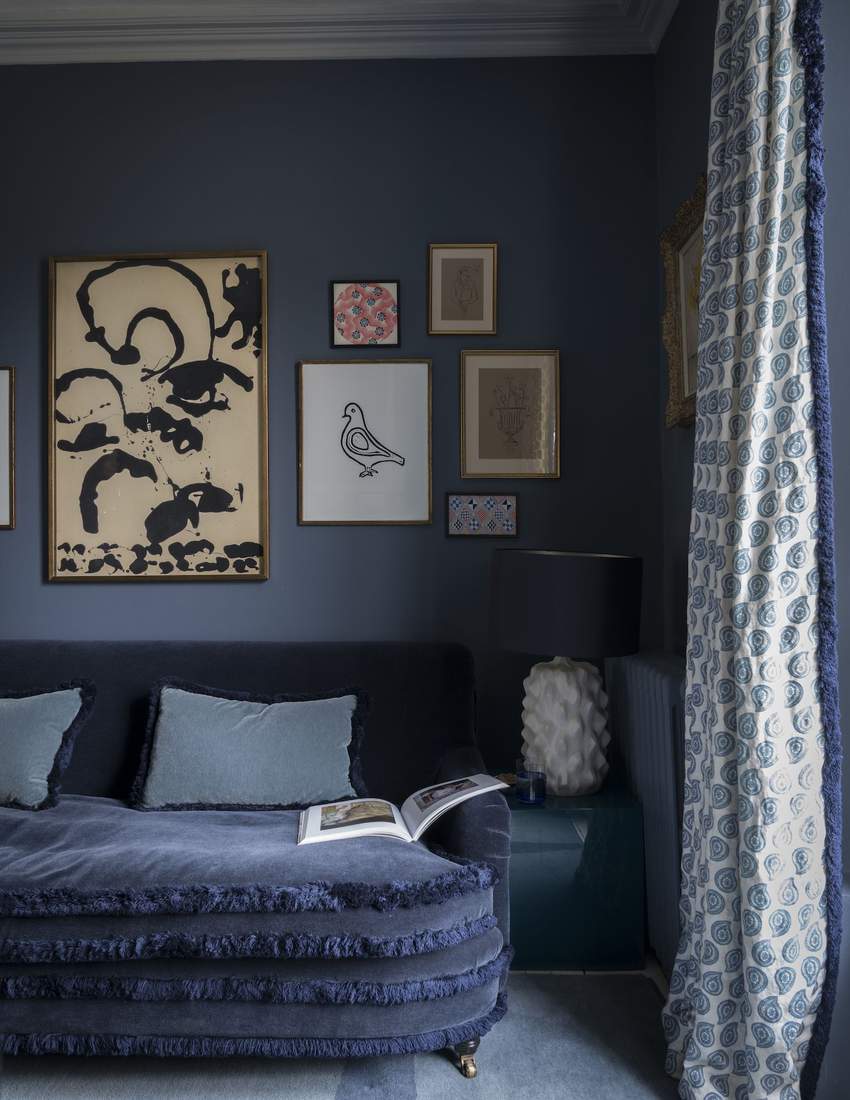 Neutral tweed curtains in a cozy, library-inspired living room.