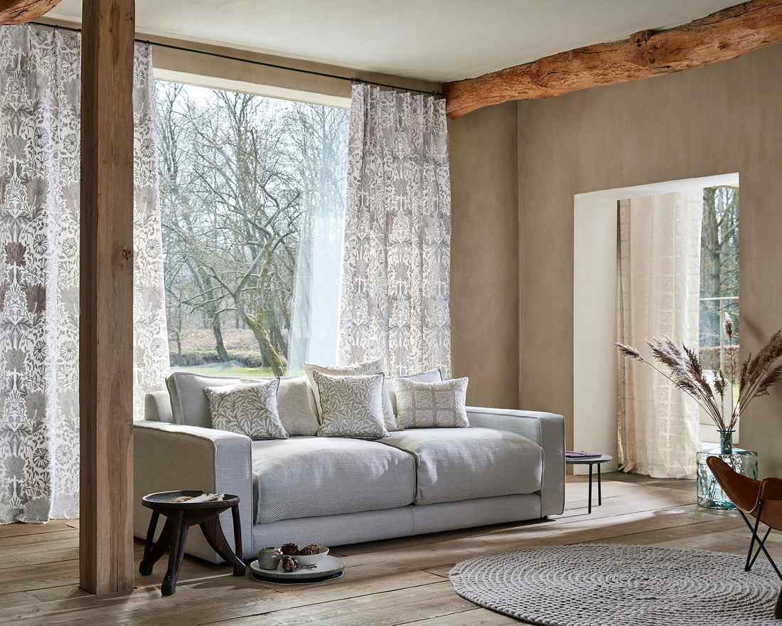 Wide white wooden blinds in a bright, modern minimalist living room.