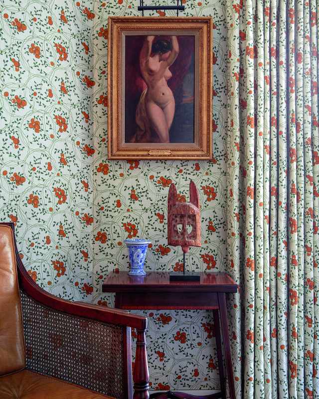 Long curtains that pool on the floor in a grand, high-ceilinged living room.