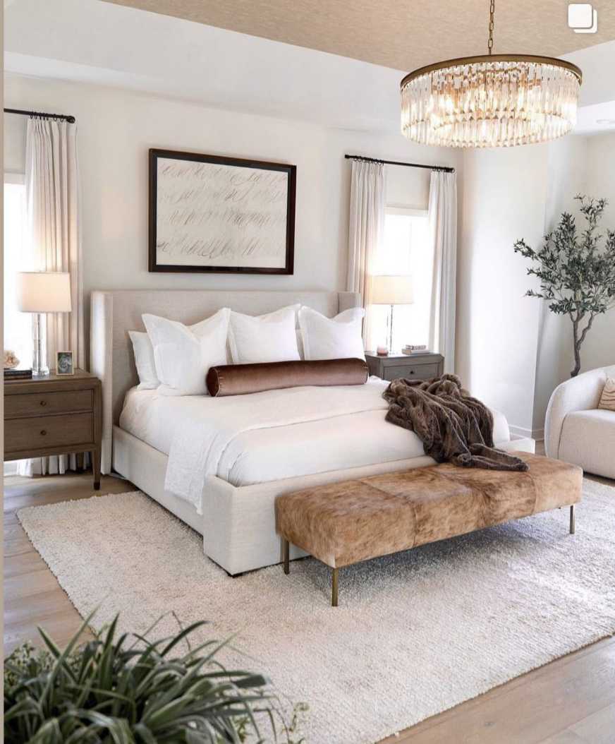 Luxury bedroom with a crystal drum chandelier and a decorative bolster pillow