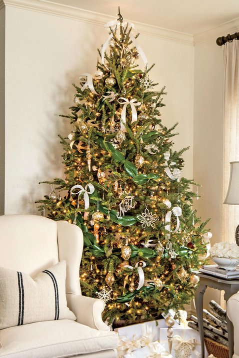 Southern-style living room tree with velvet copper ribbon, magnolia leaves, traditional fireplace lighting