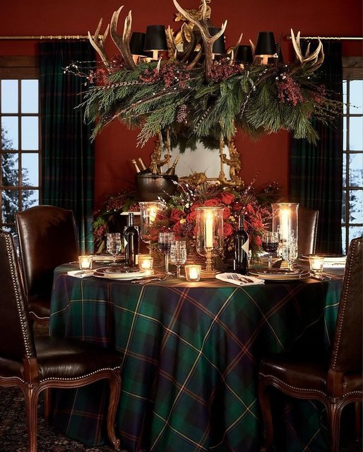 Fireplace mantel with full‑length garland, coordinated stockings, brass candlesticks, soft glow.