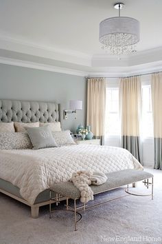Clean spa-like master bedroom with white linens and natural materials